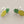 Load image into Gallery viewer, Pineapple-shaped earrings with green and yellow details on a gray background
