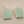 Load image into Gallery viewer, Pair of earrings with rectangular green stones on a gray background
