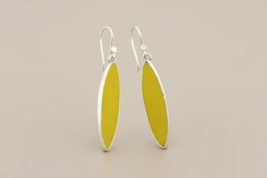 Yellow earrings with silver hooks on a gray background