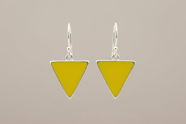 Yellow triangle earrings with silver frames on a gray background