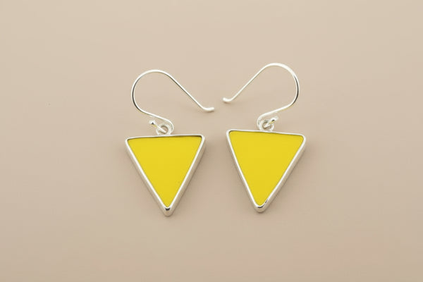 Yellow triangle earrings with silver hooks on a gray background