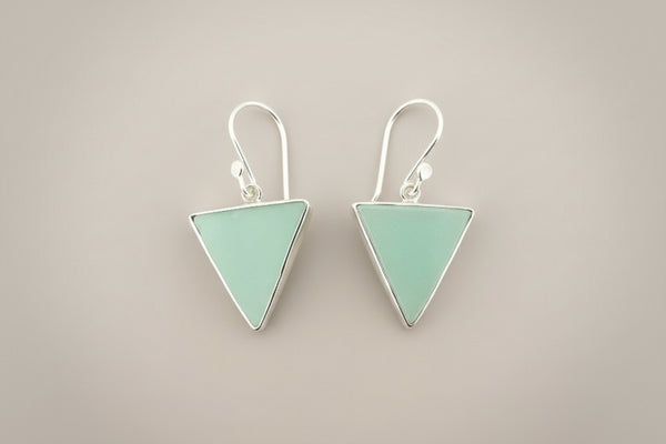 Pair of triangle-shaped earrings on a gray background