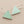 Load image into Gallery viewer, Pair of triangle-shaped earrings with green stones on a gray background
