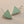 Load image into Gallery viewer, Pair of triangle-shaped earrings with light green stones on a gray background
