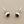 Load image into Gallery viewer, Pair of silver earrings with black stones on a gray background
