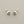Load image into Gallery viewer, Pair of silver earrings on a gray background
