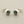 Load image into Gallery viewer, Pair of silver stud earrings with gemstones on a gray background

