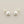 Load image into Gallery viewer, Pair of pearl stud earrings on a gray background
