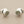 Load image into Gallery viewer, Pair of silver earrings with gemstone-like centers on a gray background
