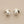 Load image into Gallery viewer, Silver earrings with pearl centers on a gray background

