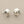 Load image into Gallery viewer, Pair of silver stud earrings with pearl centers on a gray background
