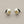 Load image into Gallery viewer, Pair of silver stud earrings with a yellow gemstone on a gray background
