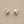 Load image into Gallery viewer, Pair of silver stud earrings with green gemstones on a gray background
