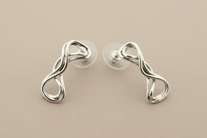 Pair of silver earrings on gray background