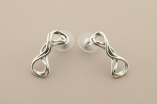 Pair of silver earrings on gray background