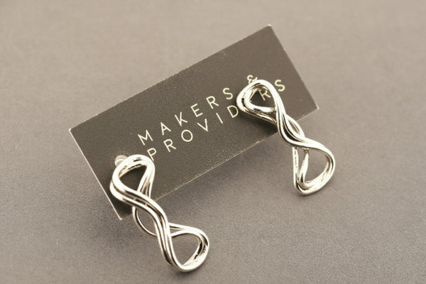 Silver infinity-shaped earring on a 'Makers & Providers' card against a gray background
