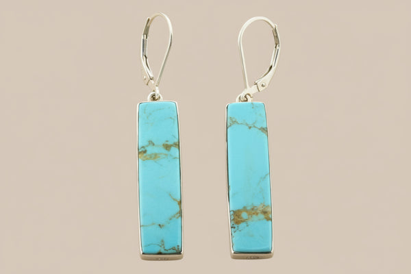 Turquoise bar earrings on a gray background