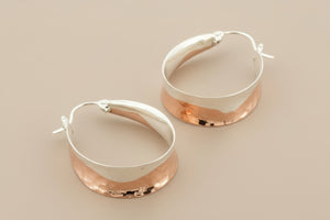 Pair of silver hoop earrings on a gray background