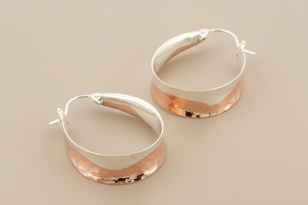 Pair of silver hoop earrings on a gray background