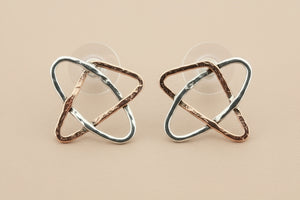 Pair of geometric earrings on a gray background