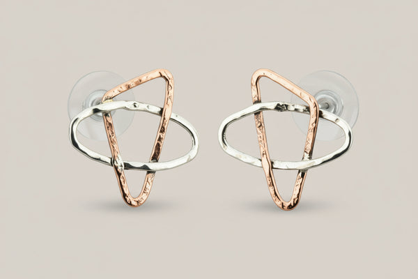 Pair of geometric earrings on a gray background