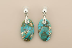 Turquoise stone earrings with silver posts on a gray background