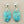 Load image into Gallery viewer, Turquoise earrings with silver hooks on a gray background
