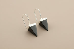 Pair of geometric earrings on a gray background