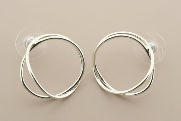Pair of silver hoop earrings on a gray background