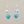 Load image into Gallery viewer, Pair of silver earrings with turquoise stones on a gray background
