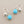Load image into Gallery viewer, Turquoise teardrop earrings with silver hooks on a gray background
