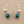 Load image into Gallery viewer, Silver earrings with green gemstones on a gray background
