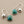 Load image into Gallery viewer, Silver earrings with green gemstones on a gray background
