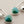 Load image into Gallery viewer, Pair of earrings with green gemstones and silver hooks on a gray background
