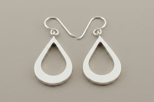 Pair of silver teardrop earrings on a gray background