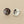 Load image into Gallery viewer, Two round silver earrings with textured surfaces on a gray background
