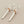 Load image into Gallery viewer, Pair of silver and rose gold earrings on a gray background
