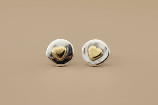 Pair of heart-shaped earrings on a gray background