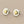 Load image into Gallery viewer, Pair of gold heart stud earrings on a gray background
