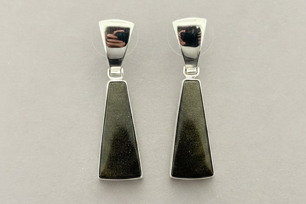 Pair of silver earrings with greenstone pendants on a gray background