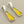 Load image into Gallery viewer, Pair of earrings with yellow and silver design on a gray background
