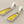 Load image into Gallery viewer, Pair of earrings with yellow center and silver frame on a gray background
