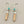 Load image into Gallery viewer, Earrings with silver, copper and turquoise stone design on a gray background
