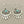 Load image into Gallery viewer, A pair of silver-toned dangle earrings with a fan or sunburst cutout design and a small round turquoise stone at the center, shown on a dark gray background.
