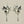 Load image into Gallery viewer, A pair of silver owl dangle earrings with small pearl-like beads, shown on a dark gray background.

