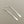 Load image into Gallery viewer, Pair of silver earrings on a gray background
