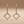 Load image into Gallery viewer, Pair of silver square earrings on a beige background
