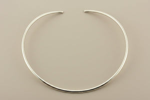 Silver necklace on a gray background