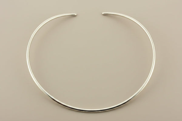 Silver necklace on a gray background