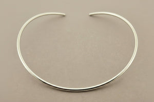 Silver necklace on a gray background